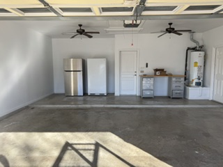 Finished garage with painted walls and ceiling fans